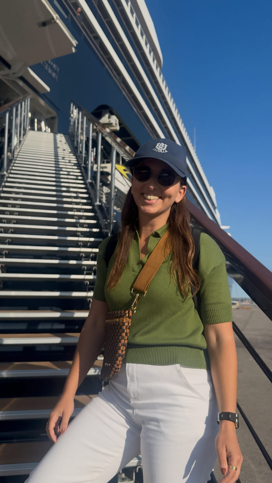 Alex Hyat smiling on the steps of a yacht